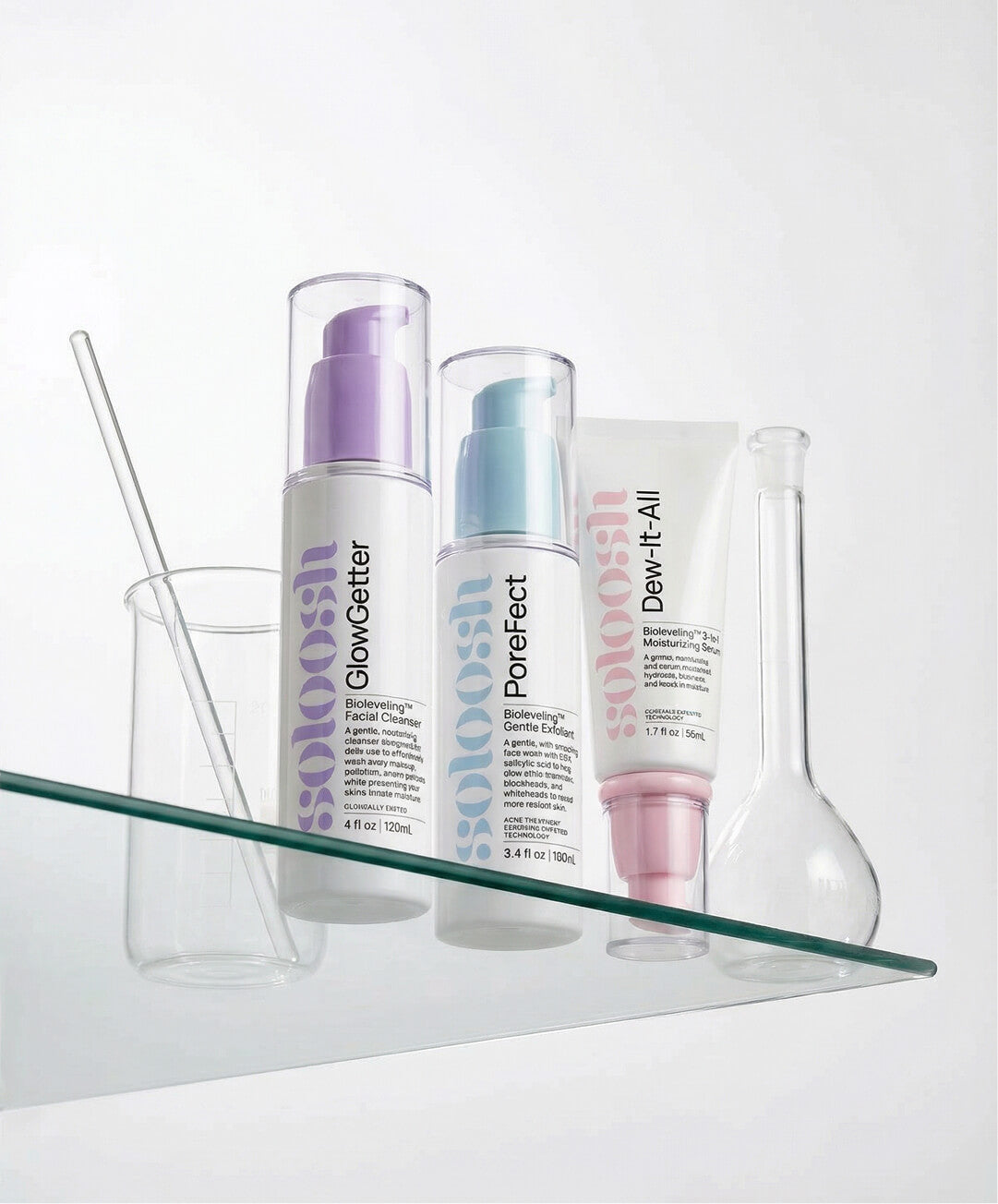 Set of Soloosh skincare products on a glass shelf with a white background